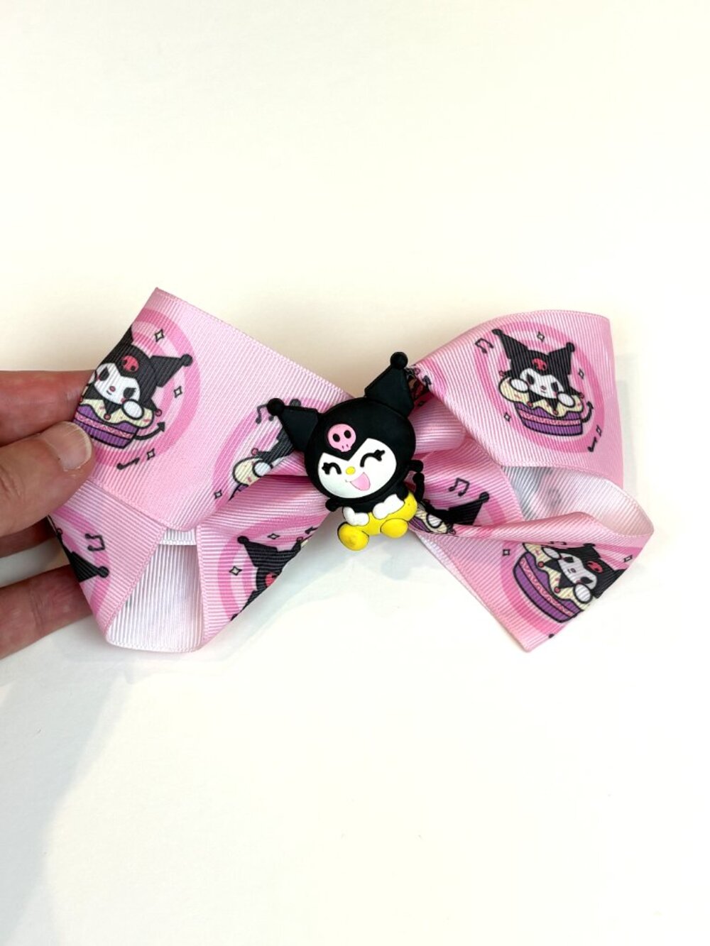 Cute pink Sanrio hair bow featuring Kuromi and an all-over Kuromi pattern. New